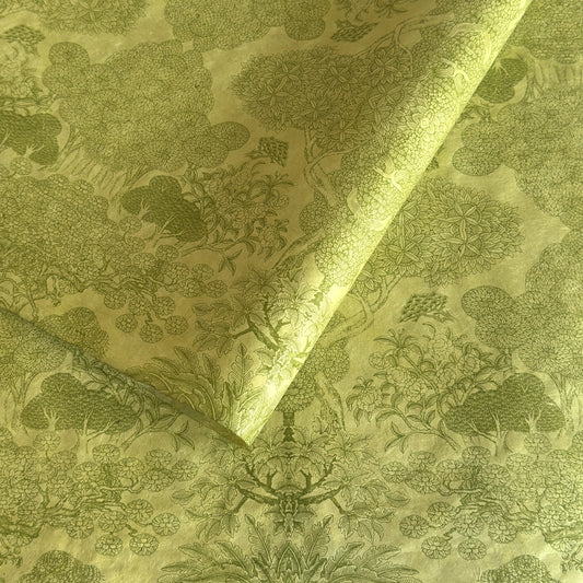 Nepalese handmade decorative lokta paper sheet with a detailed design of trees and flowers in dark green screen printed on a green lokta paper.