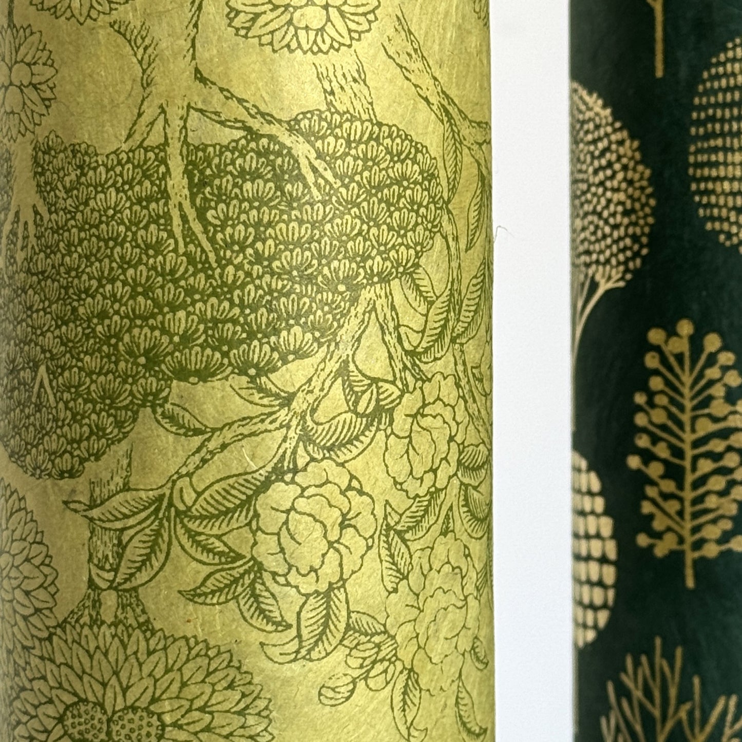 Nepalese handmade decorative lokta paper sheet with a detailed design of trees and flowers in dark green screen printed on a green lokta paper.