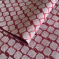 Nepalese handmade decorative lokta paper sheet with a white leaf pattern screen printed on a burgundy lokta paper.