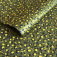 Nepalese handmade decorative lokta paper sheet with an animal print design in two colours, yellow and black, screen printed on a green lokta paper.