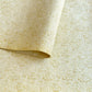 Nepalese handmade decorative lokta paper sheet with a metallic gold wave design screen printed on an ivory lokta paper.