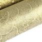 Nepalese handmade decorative lokta paper sheet with a metallic gold wave design screen printed on an ivory lokta paper. close up