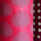 Nepalese handmade decorative lokta paper sheet with a lilac palm leaf design screen printed on a fuchsia pink lokta paper. close up
