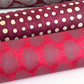 Nepalese handmade decorative lokta paper sheet with a lilac palm leaf design screen printed on a fuchsia pink lokta paper. Rolled