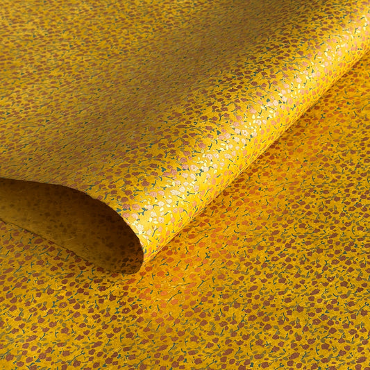 A delicate floral pattern in gold, blush and green screen-printed by hand on mustard yellow lokta paper.