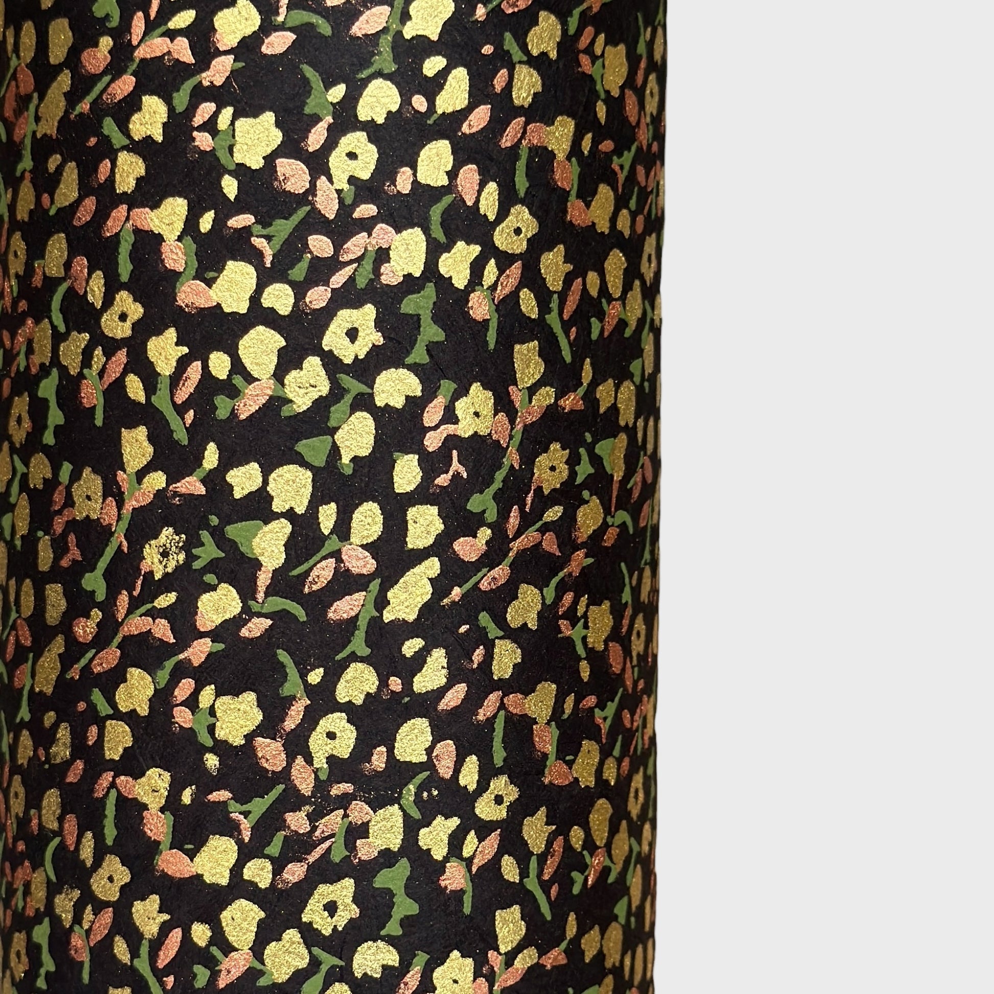 A delicate floral pattern in gold, blush and green screen-printed by hand on black lokta paper.