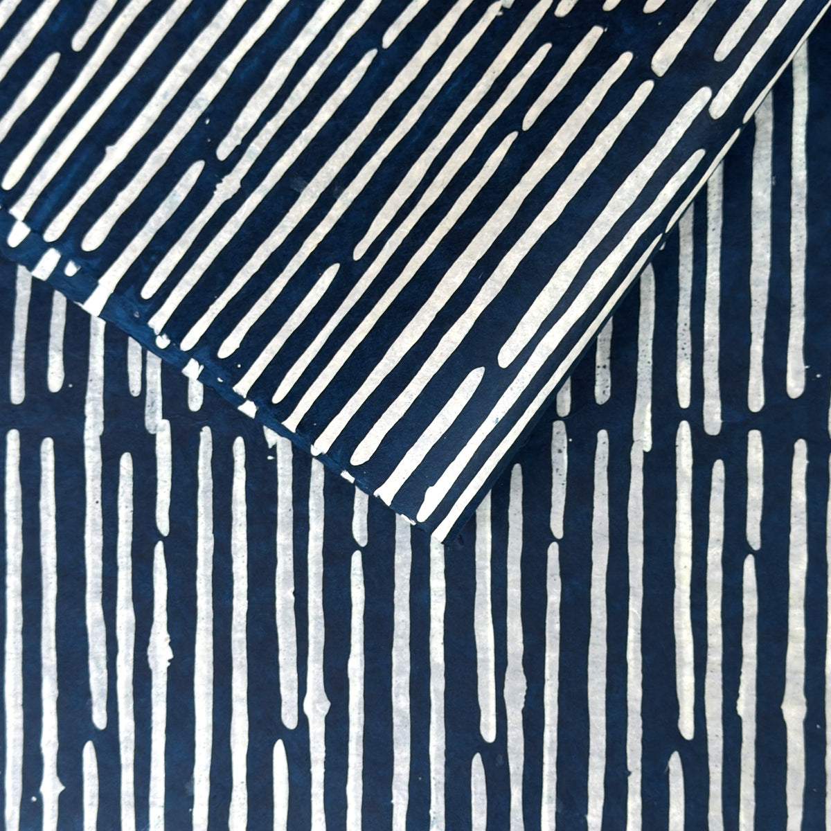 Nepalese handmade decorative lokta paper sheet with a stripe pattern in petrol blue and white.  Batik dyed using carved wooden blocks