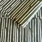 Nepalese handmade decorative lokta paper sheet with a stripe pattern in mossy and white.  Batik dyed using carved wooden blocks. 