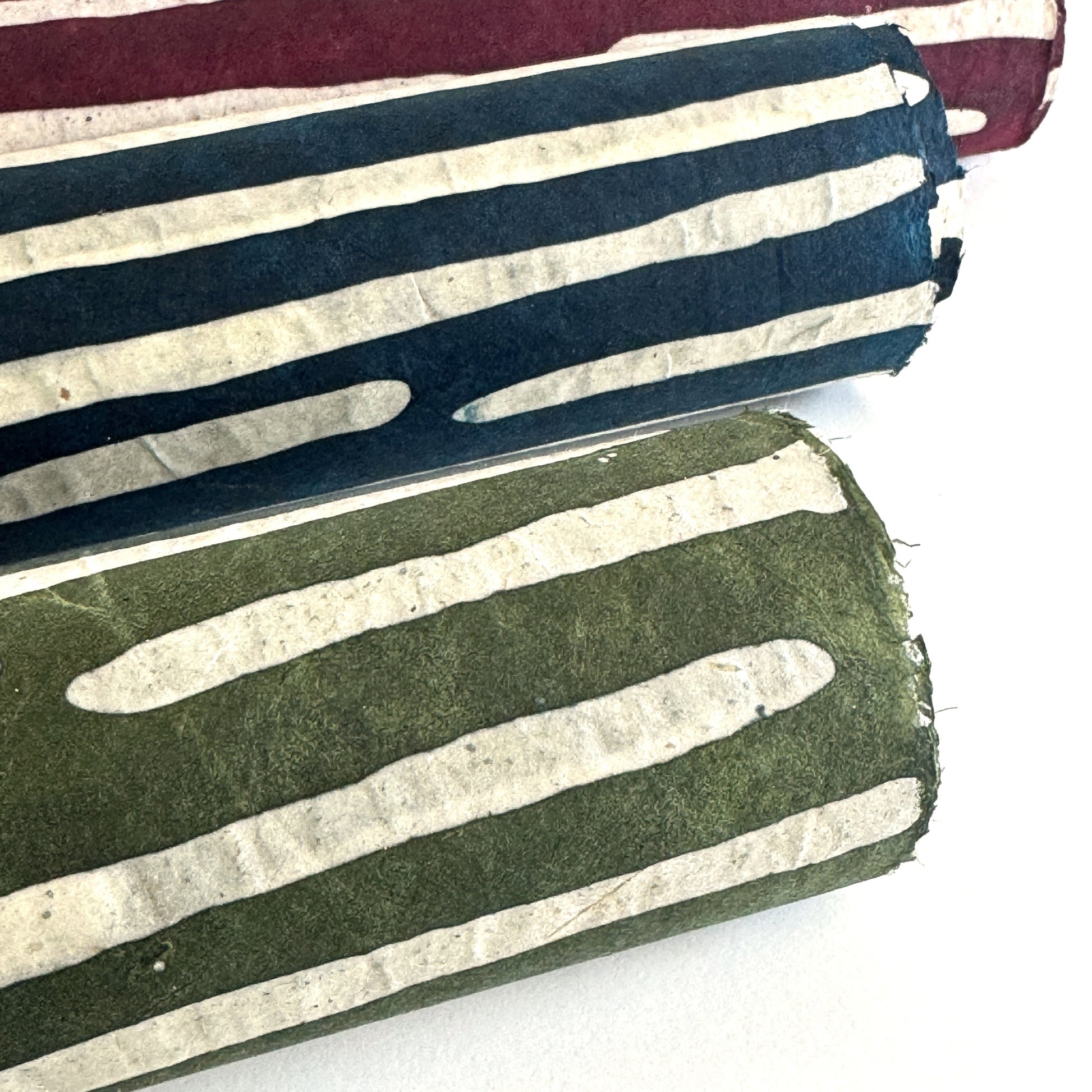 Nepalese handmade decorative lokta paper sheet with a stripe pattern in mossy and white.  Batik dyed using carved wooden blocks. Rolled