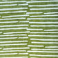 Nepalese handmade decorative lokta paper sheet with a stripe pattern in mossy and white.  Batik dyed using carved wooden blocks. Picture next to light to show the translucent nature