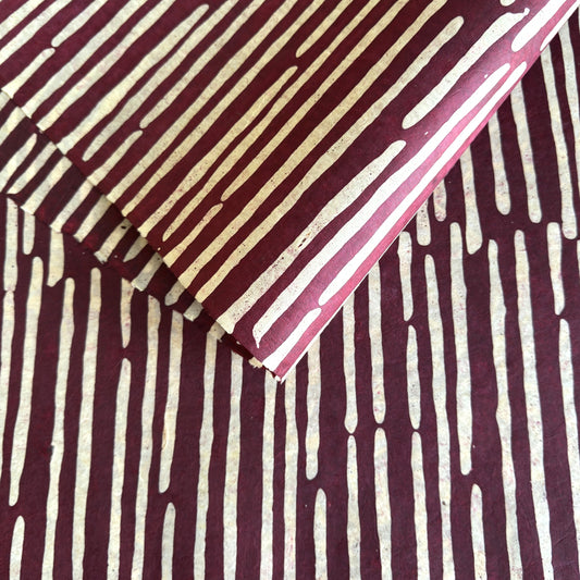 Nepalese handmade decorative lokta paper sheet with a stripe pattern in burgundy and white.  Batik dyed using carved wooden blocks. 