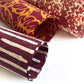 Nepalese handmade decorative lokta paper sheet with a stripe pattern in burgundy and white.  Batik dyed using carved wooden blocks. Rolled