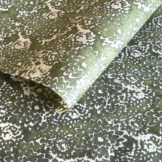Nepalese handmade decorative lokta paper sheet with a floral pattern in green and cream.  Batik dyed using carved wooden blocks.