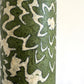 Nepalese handmade decorative lokta paper sheet with a floral pattern in green and cream.  Batik dyed using carved wooden blocks.