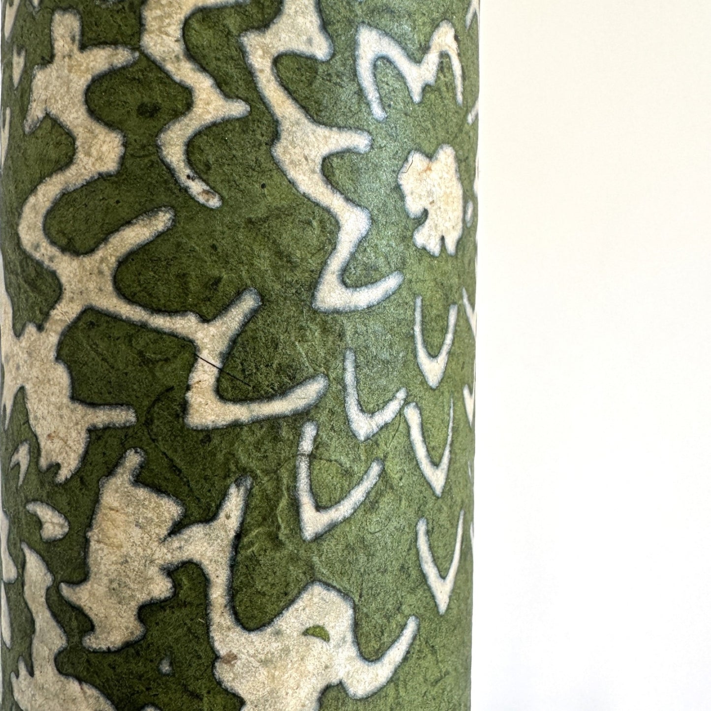 Nepalese handmade decorative lokta paper sheet with a floral pattern in green and cream.  Batik dyed using carved wooden blocks.