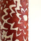 Nepalese handmade decorative lokta paper sheet with a floral pattern in rust and cream.  Batik dyed using carved wooden blocks.