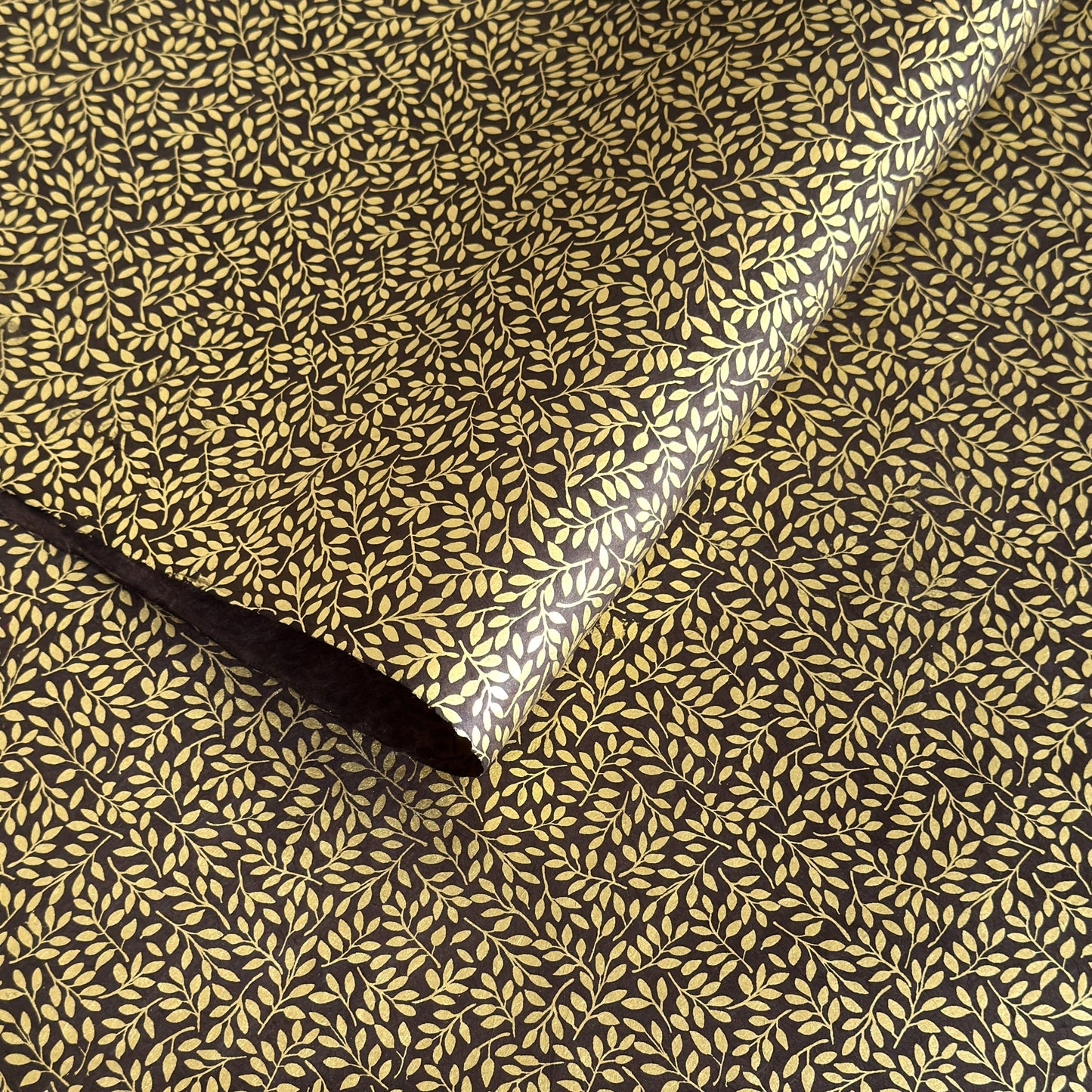 Nepalese handmade decorative lokta paper sheet with a metallic gold willow design screen printed on a dusty grape lokta paper.