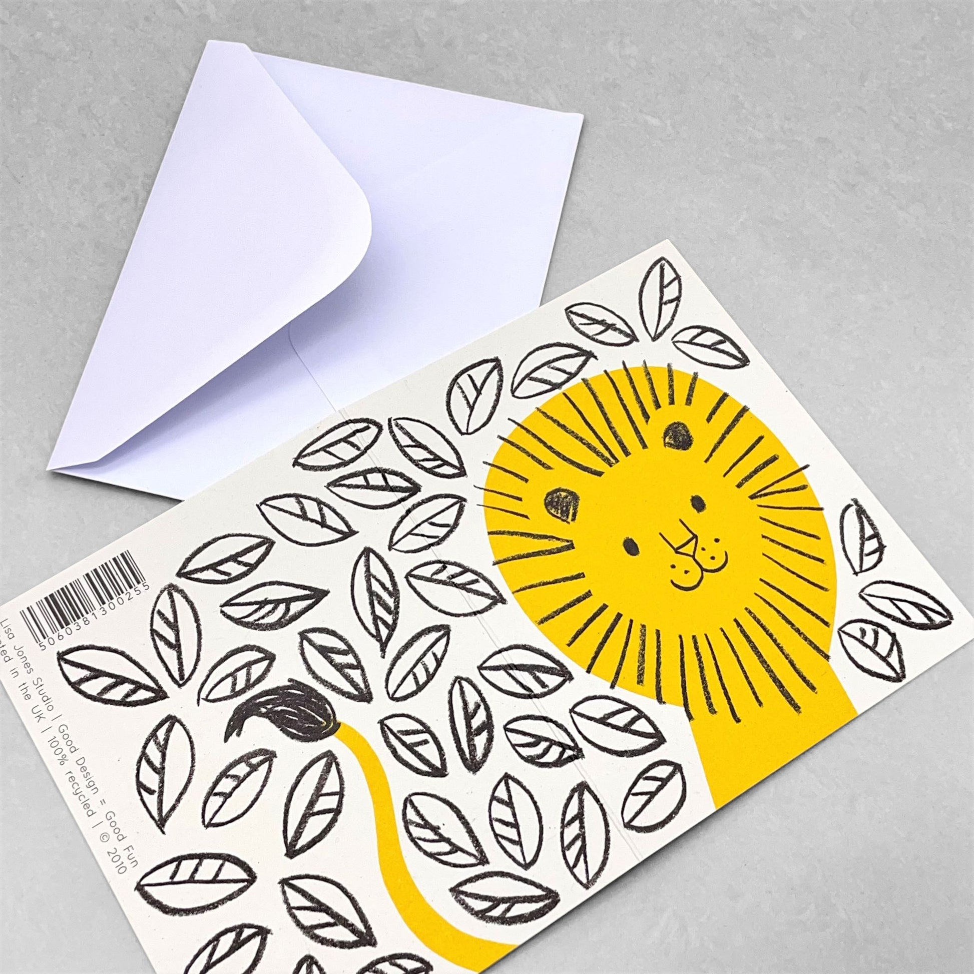 Small greeting card with a drawing of a yellow lion surrounded by black sketched leaves on a white backdrop by Lisa Jones Studio