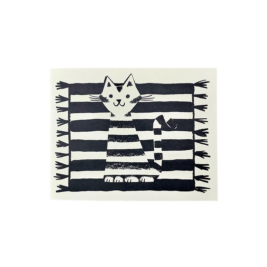 Small greeting card of a black and white stripy cat sitting on a black and white stripy rug by Lisa Jones Studio
