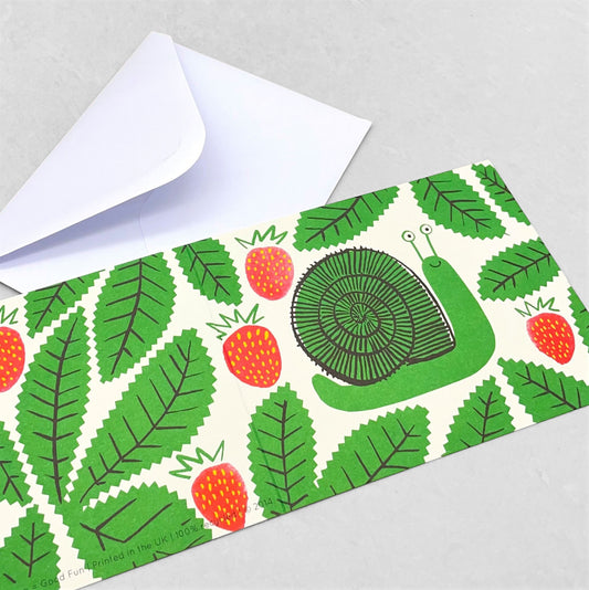 Small greetings card of a drawing of a green snail amongst red strawberries and green leaves by Lisa jones Studio