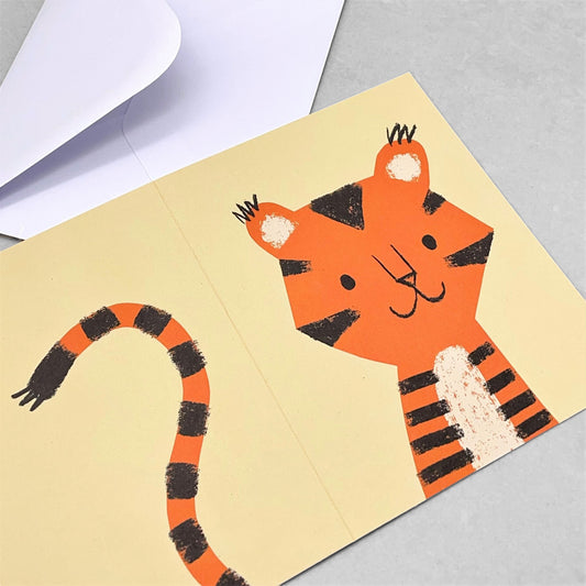 Small greetings card of a drawing of an orange tiger cub with cream backdrop by Lisa Jones Studio