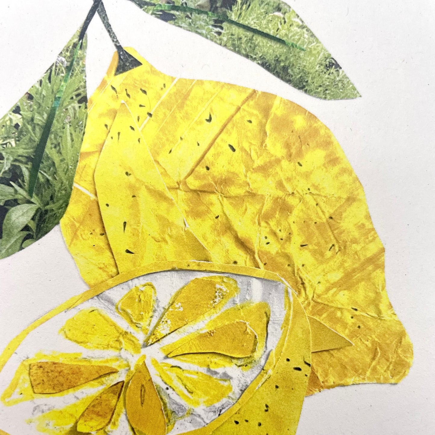 Greetings card by Megan Fartharly of a yellow collaged lemon, close up of the collage lemon
