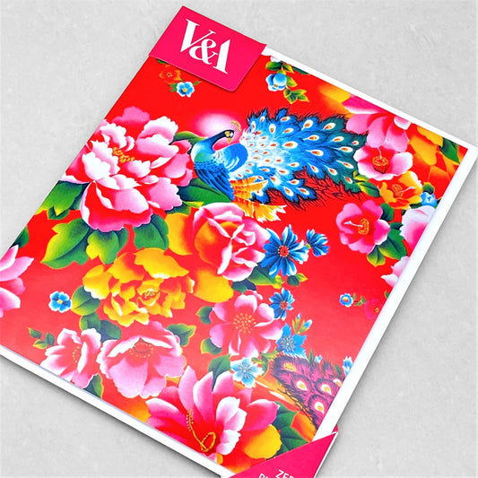greetings card showing a bright blue peacock amongst flowers in red and pink