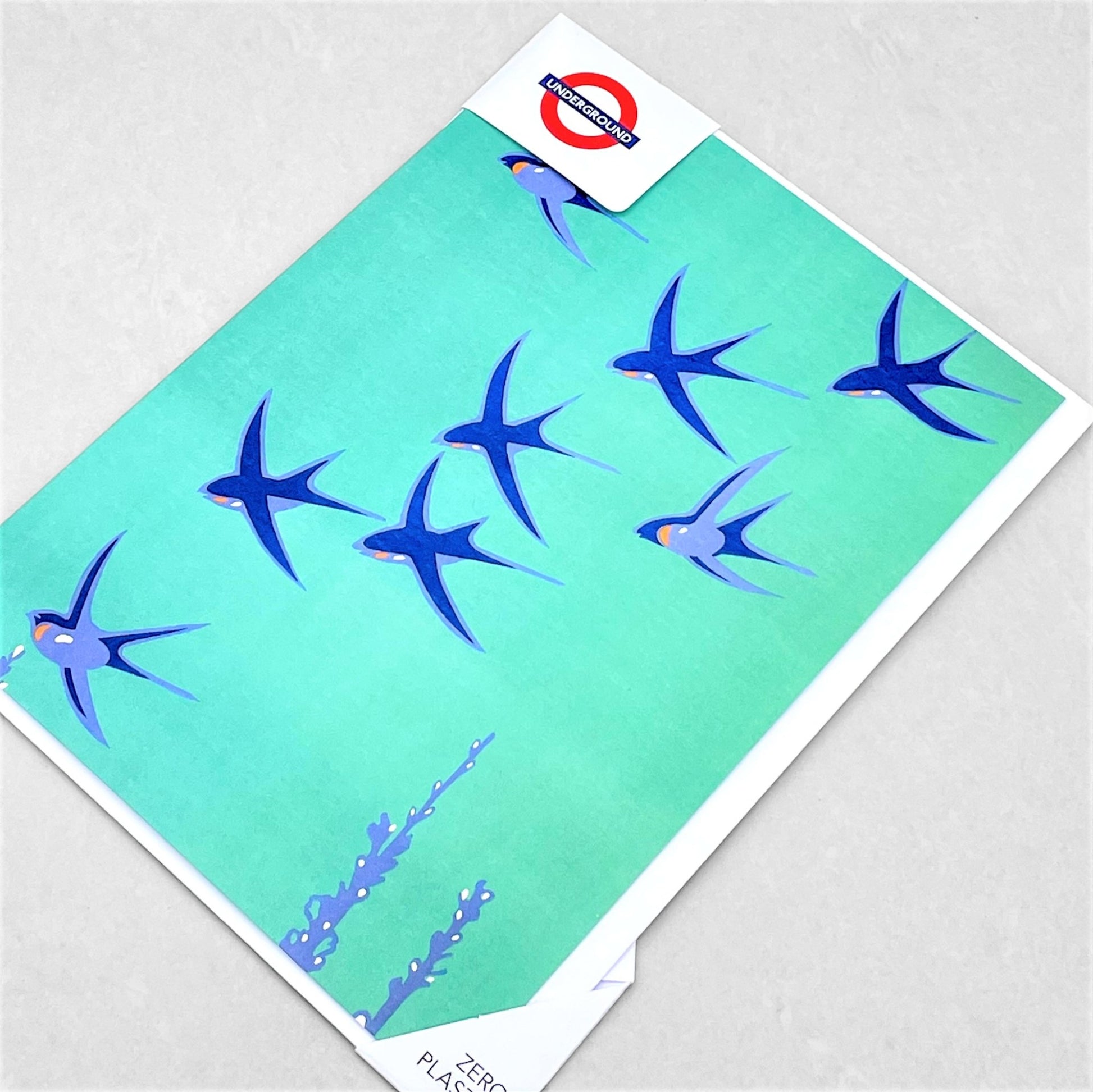 greetings card showing abstract blue birds flying with an aqua backdrop