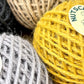 Gift box of 6 coloured jute twine balls by Nutscene.  Close up of the balls of twine showing the mustard yellow and grey.