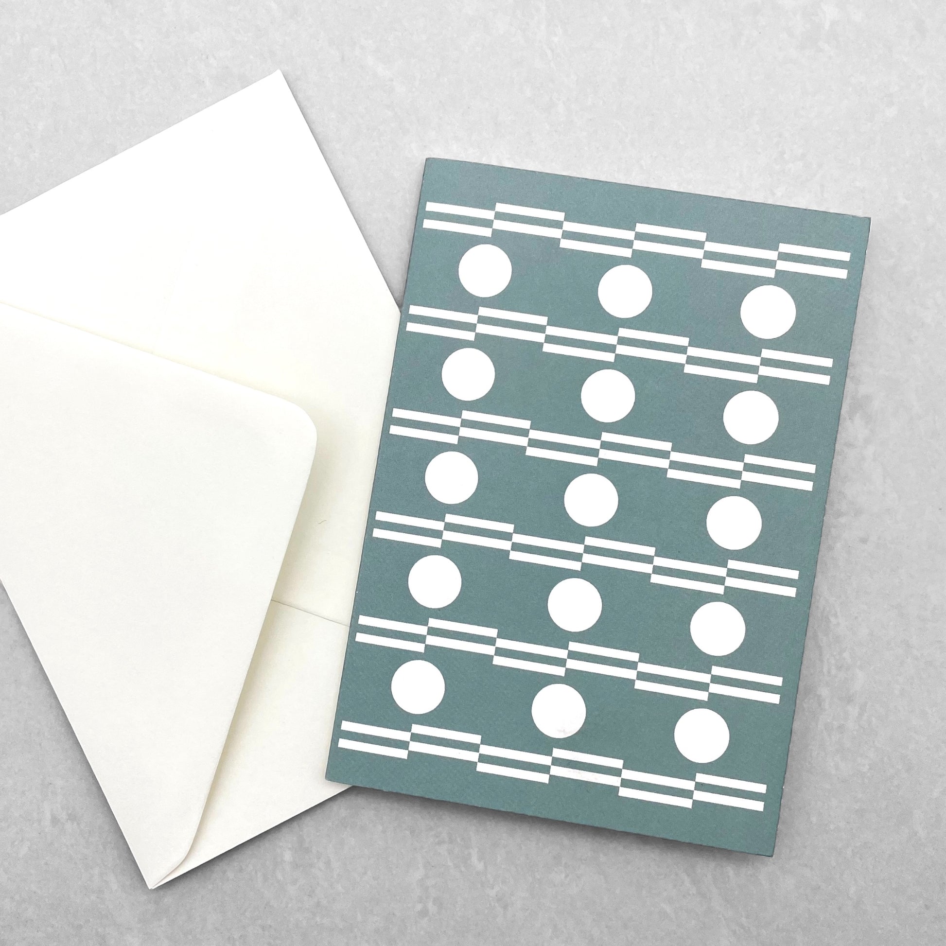 greetings card with abstract circle design in white and teal by Ola Studio