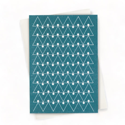 Greetings card by Ola Studio with a triangular geometric design in white on a deep teal background