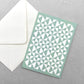 greetings card with abstract triangular pattern in white and aquamarine by Ola Studio