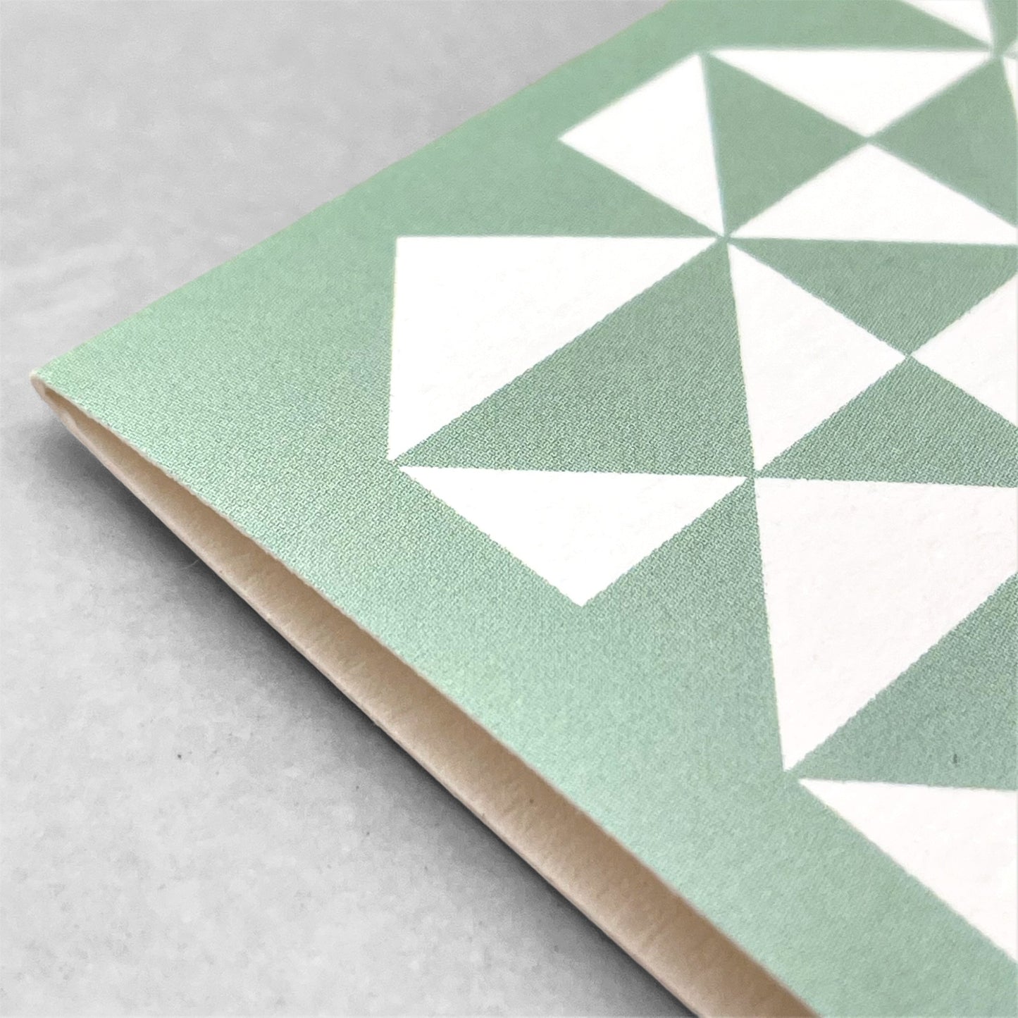greetings card with abstract triangular pattern in white and aquamarine by Ola Studio
