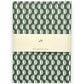slimline softcover exercise book by Ola Studio, with plain pages. Front cover is a wavy stripe design in dark green and aqua on white. Pictured with branded presentation band