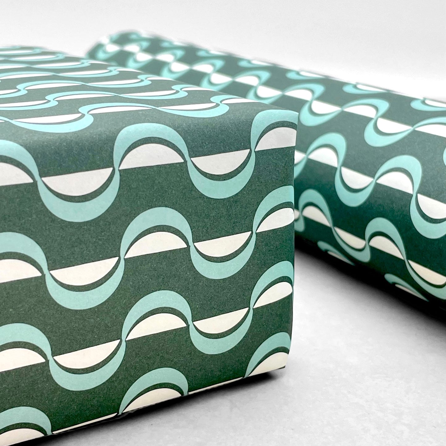 wavy striped geometric wrapping paper in forest green, aqua and white, by Ola Studio forest, close up
