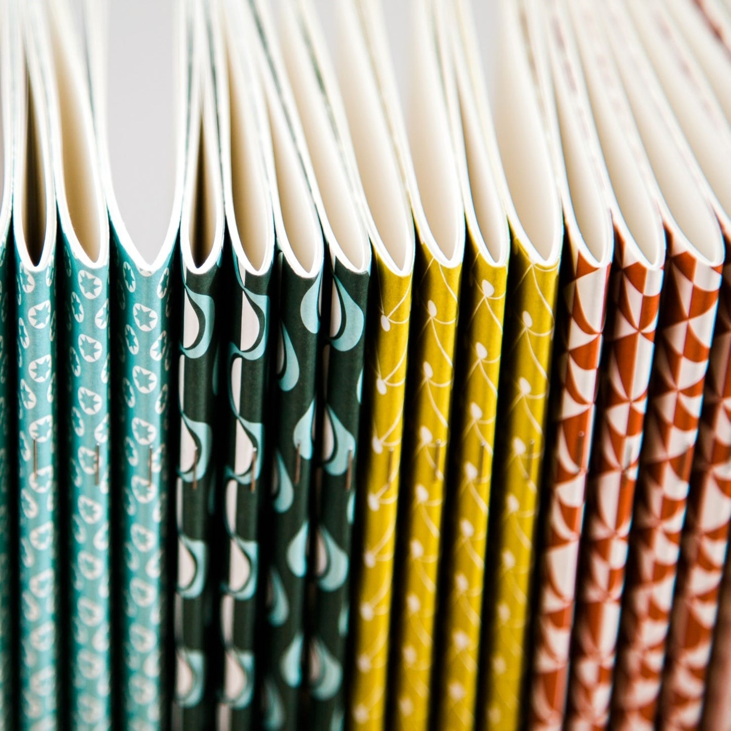 Softcover pocket notebooks by Ola Studio in a range of different patterned covers