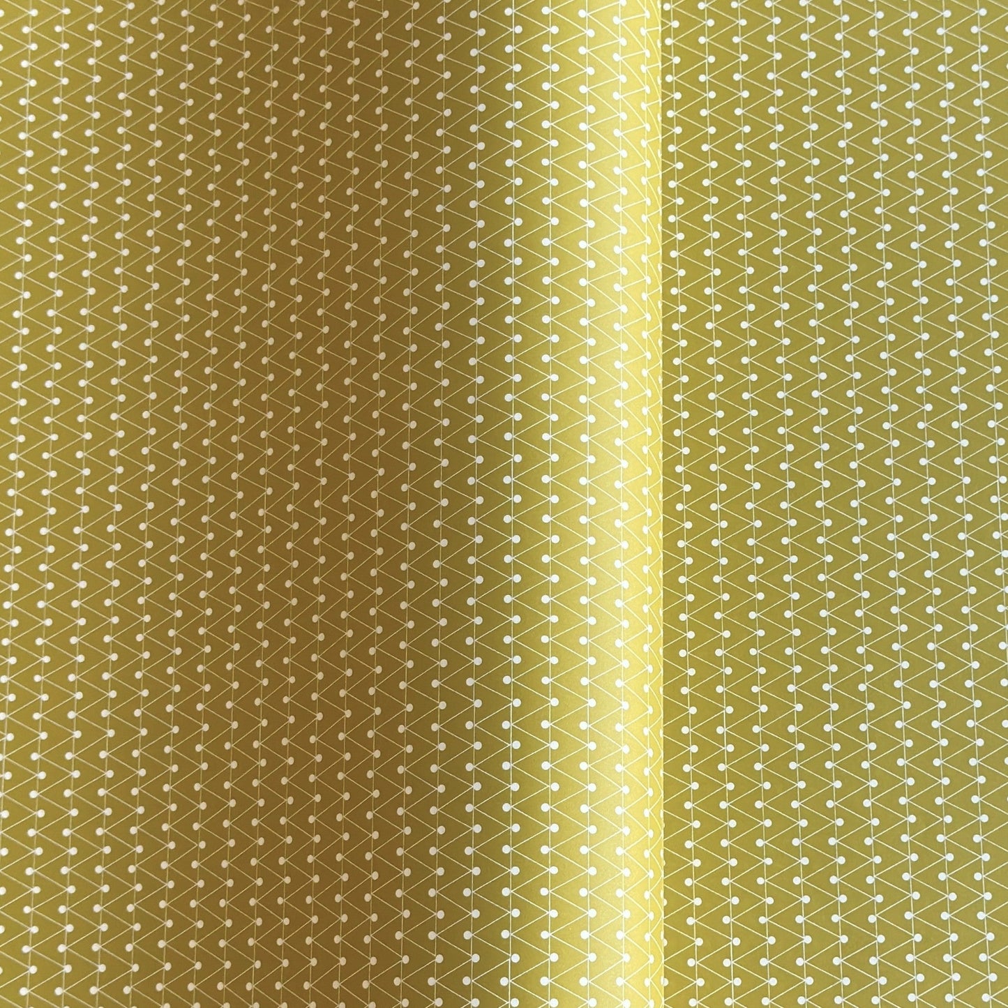 wrapping paper with abstract triangle and dot pattern in mustard and white by Ola Studio
