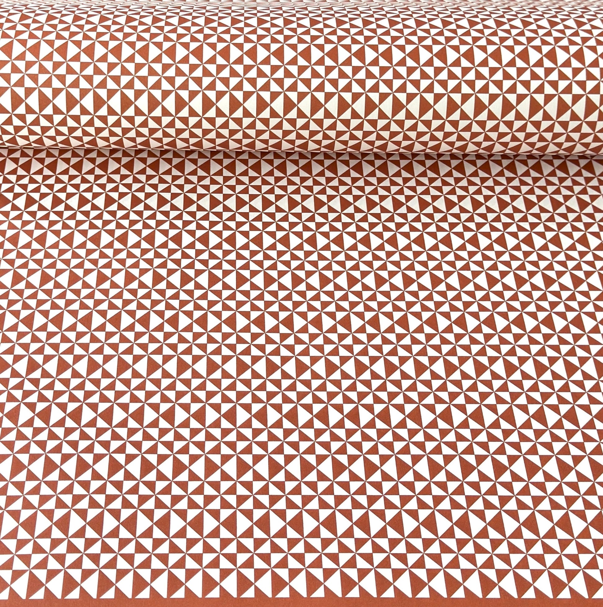 wrapping paper sheet by Ola Studio with a geometric triangle pattern in brick red on white