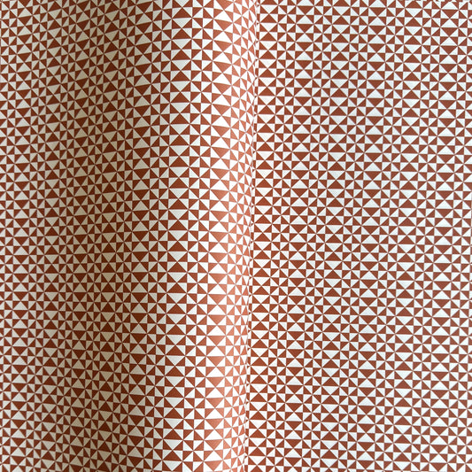 wrapping paper sheet by Ola Studio with a geometric triangle pattern in brick red on white