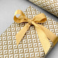wrapping paper with an abstract star pattern in gold and white by Ola Studio