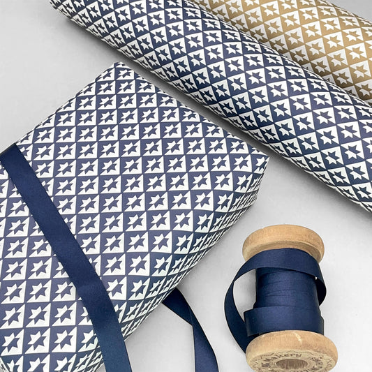 wrapping paper with an abstract star pattern in dark navy and white by Ola Studio