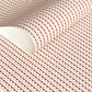 wrapping paper with an abstract circle pattern in orange and pale pink by Ola Studio