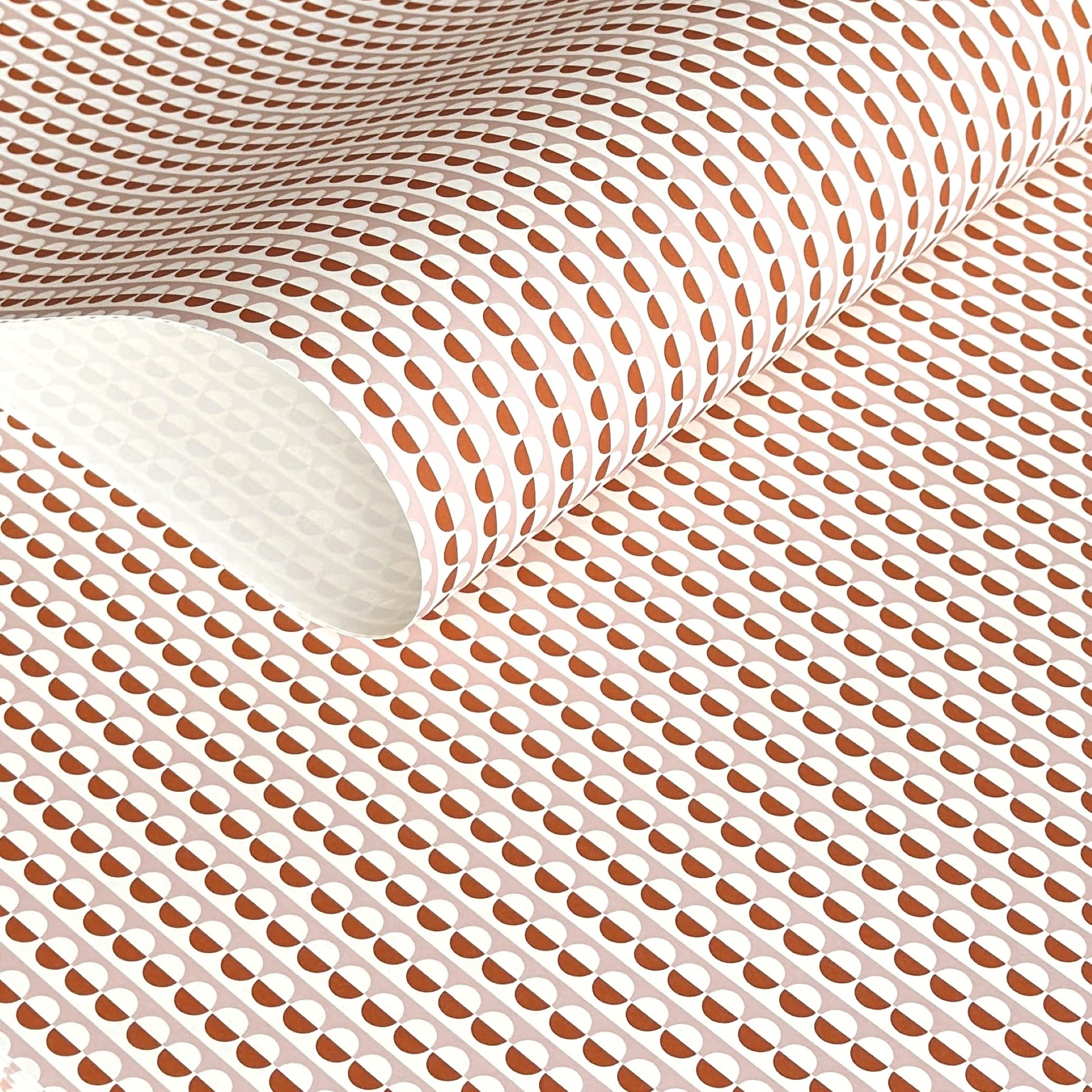 wrapping paper with an abstract circle pattern in orange and pale pink by Ola Studio