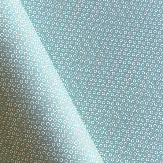 wrapping paper with an abstract tiny stars pattern in ice blue and white by Ola Studio