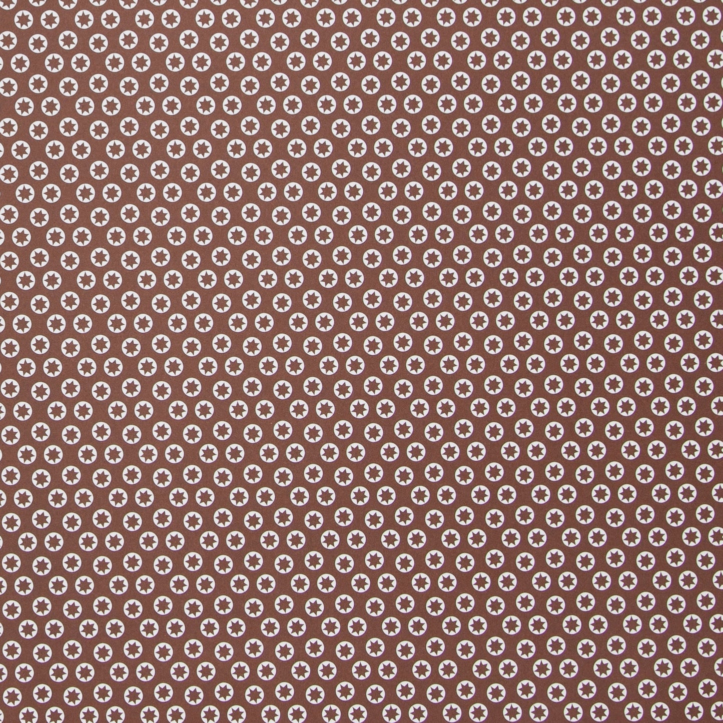 wrapping paper with an abstract tiny stars pattern in chestnut brown and white by Ola Studio