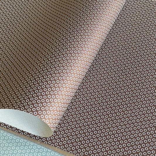 wrapping paper with an abstract tiny stars pattern in chestnut brown and white by Ola Studio