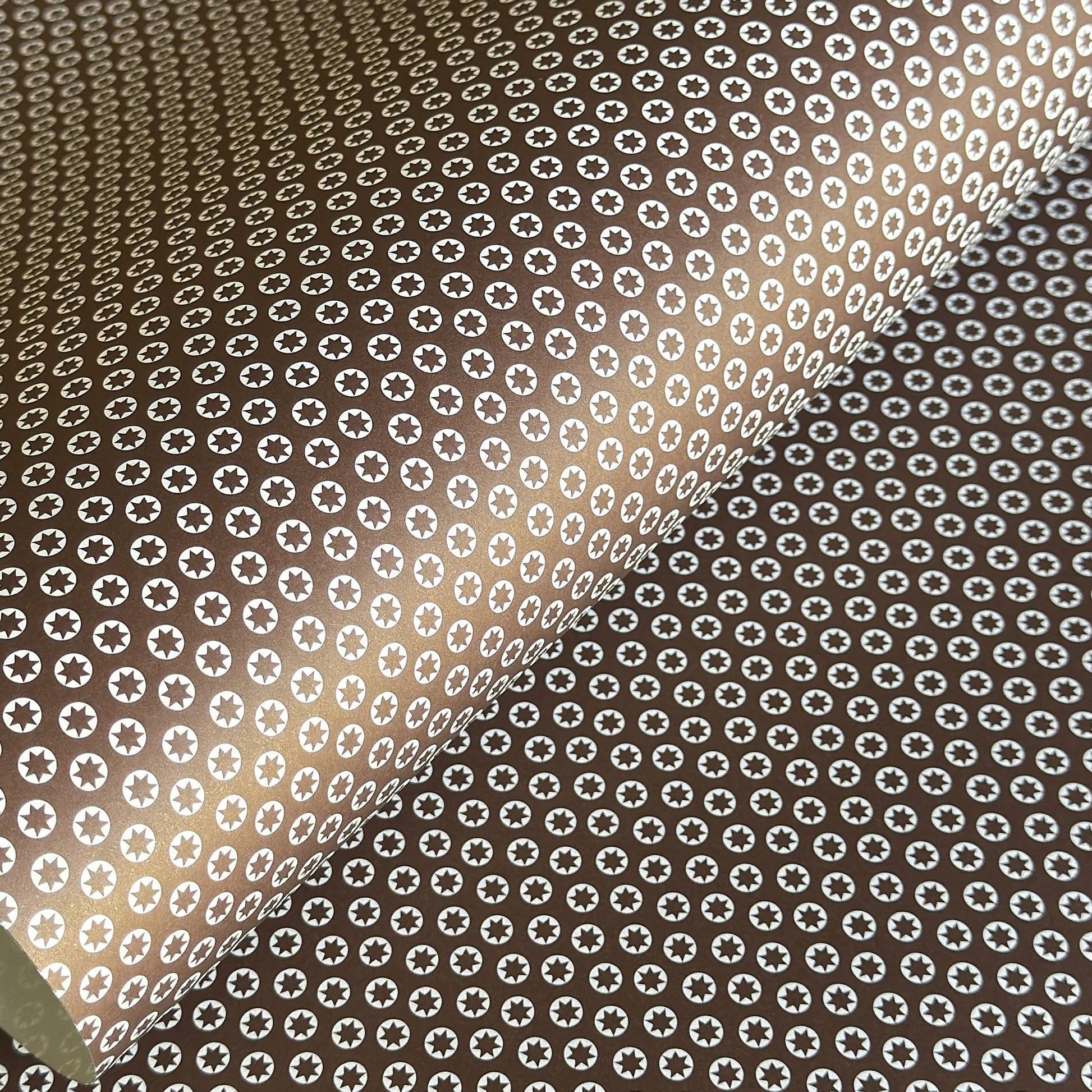 wrapping paper with an abstract tiny stars pattern in chestnut brown and white by Ola Studio