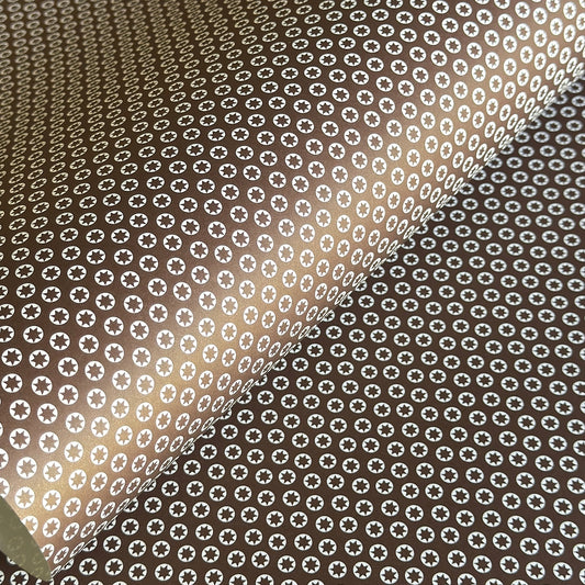 wrapping paper with an abstract tiny stars pattern in chestnut brown and white by Ola Studio
