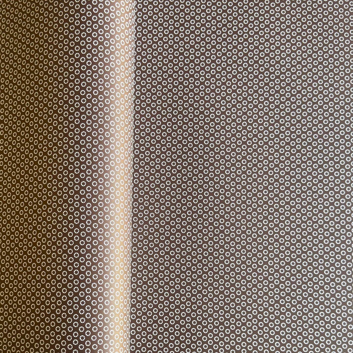 wrapping paper with an abstract tiny stars pattern in chestnut brown and white by Ola Studio