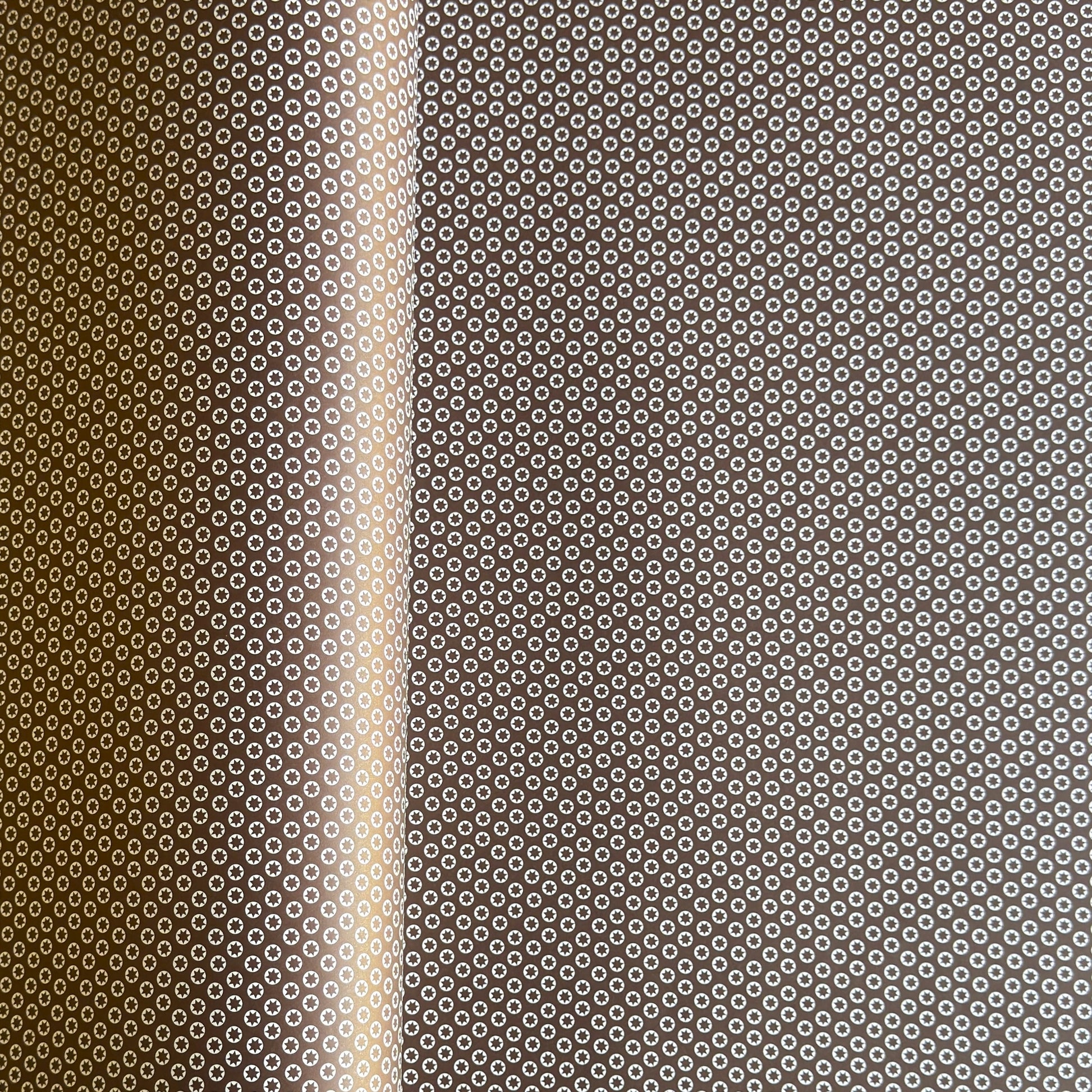 wrapping paper with an abstract tiny stars pattern in chestnut brown and white by Ola Studio
